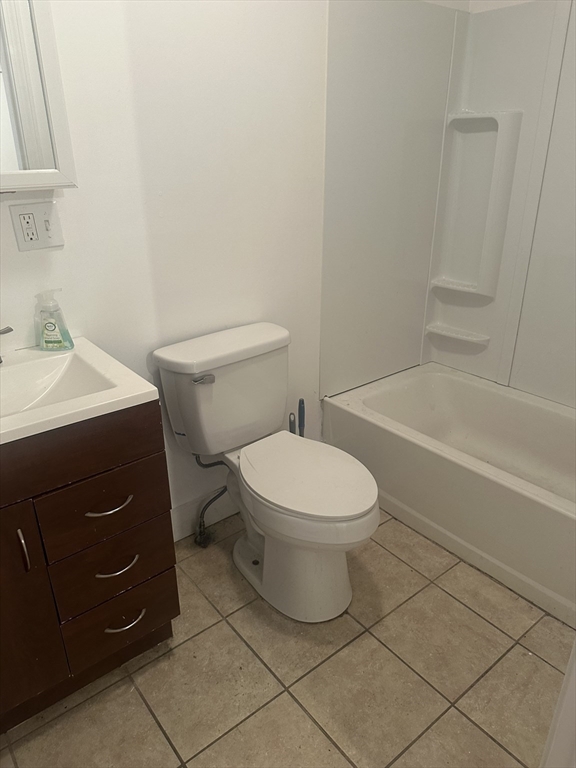 115-117 Stone Street, Unit 1 Clinton, MA 01510 - Photo 4 of 8 a white toilet sitting next to a bathroom sink