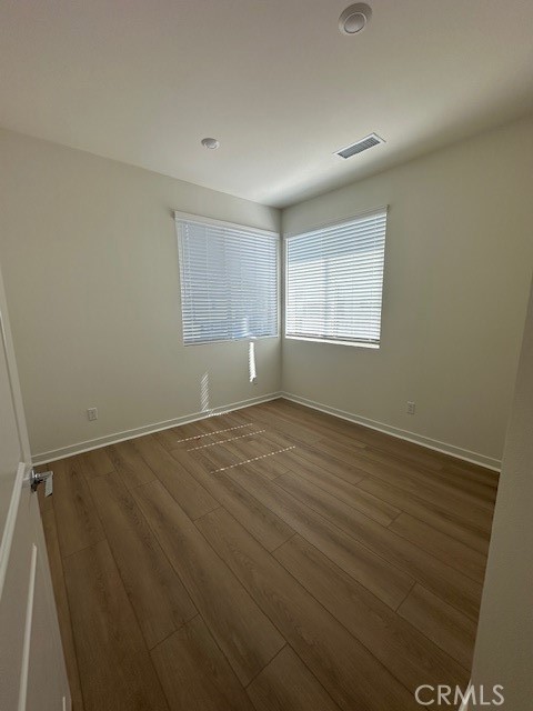1553 Lima Way, Unit 5 Placentia, CA 92870 - Photo 20 of 22 an empty room with wooden floor and windows