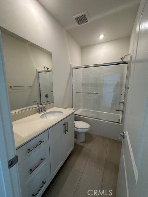 1553 Lima Way, Unit 5 Placentia, CA 92870 - Photo 21 of 22 a bathroom with a double vanity sink toilet and shower