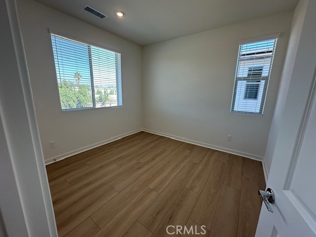 1553 Lima Way, Unit 5 Placentia, CA 92870 - Photo 22 of 22 an empty room with wooden floor and windows