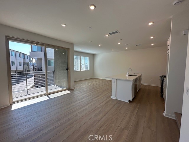 1553 Lima Way, Unit 5 Placentia, CA 92870 - Photo 3 of 22 a view of an empty room with wooden floor and a window