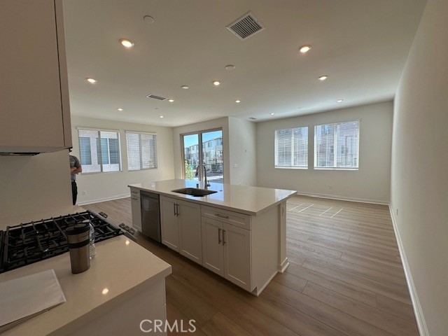 1553 Lima Way, Unit 5 Placentia, CA 92870 - Photo 4 of 22 a kitchen with stainless steel appliances a sink a stove a refrigerator and white cabinets