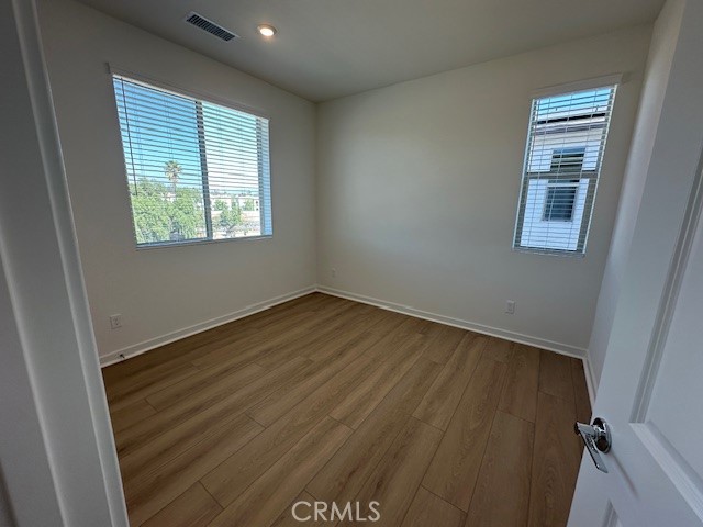 1553 Lima Way, Unit 5 Placentia, CA 92870 - Photo 5 of 22 an empty room with wooden floor and windows