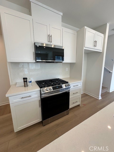 1553 Lima Way, Unit 5 Placentia, CA 92870 - Photo 6 of 22 a kitchen with stainless steel appliances granite countertop a sink and a stove