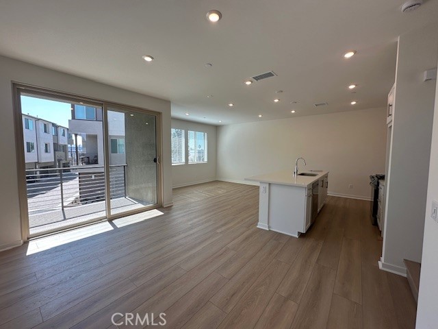 1553 Lima Way, Unit 5 Placentia, CA 92870 - Photo 8 of 22 a view of an empty room with wooden floor and a window