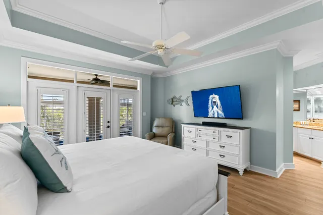 a bedroom with a bed dresser and wooden floor