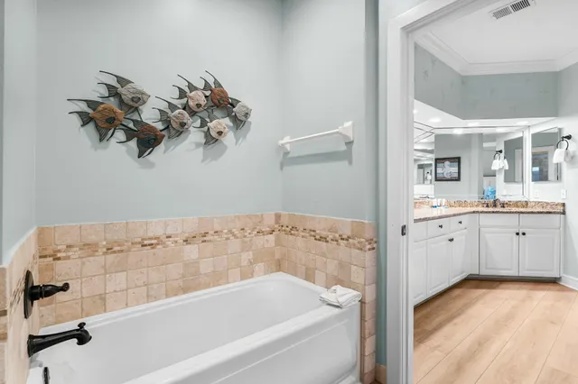 a bathroom with a bathtub sink and mirror
