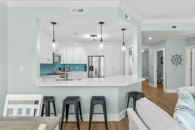 a large kitchen with a table and chairs
