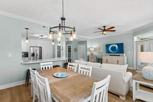 a view of a dining room with furniture and a chandelier