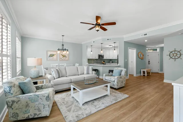 a living room with furniture and kitchen view