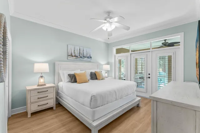 a bedroom with a large bed and a chandelier
