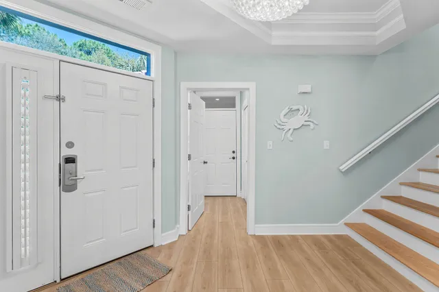 a view of a hallway with wooden floor and staircase