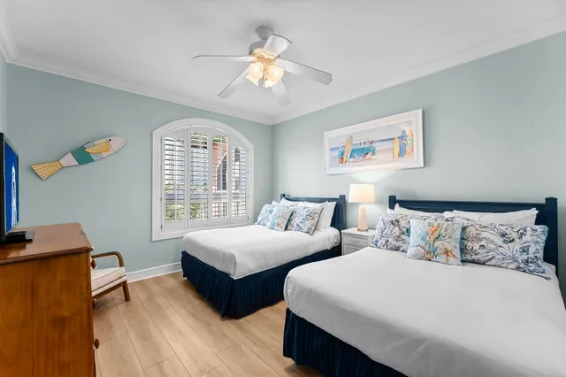 a bedroom with two beds and a chandelier