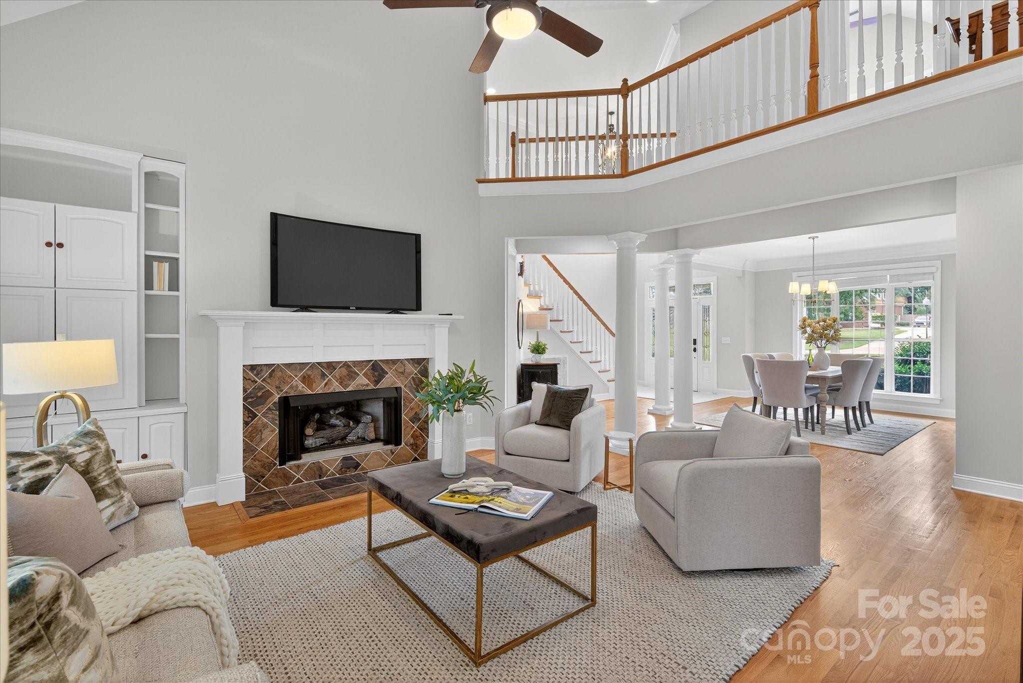 a living room with furniture a flat screen tv and a fireplace