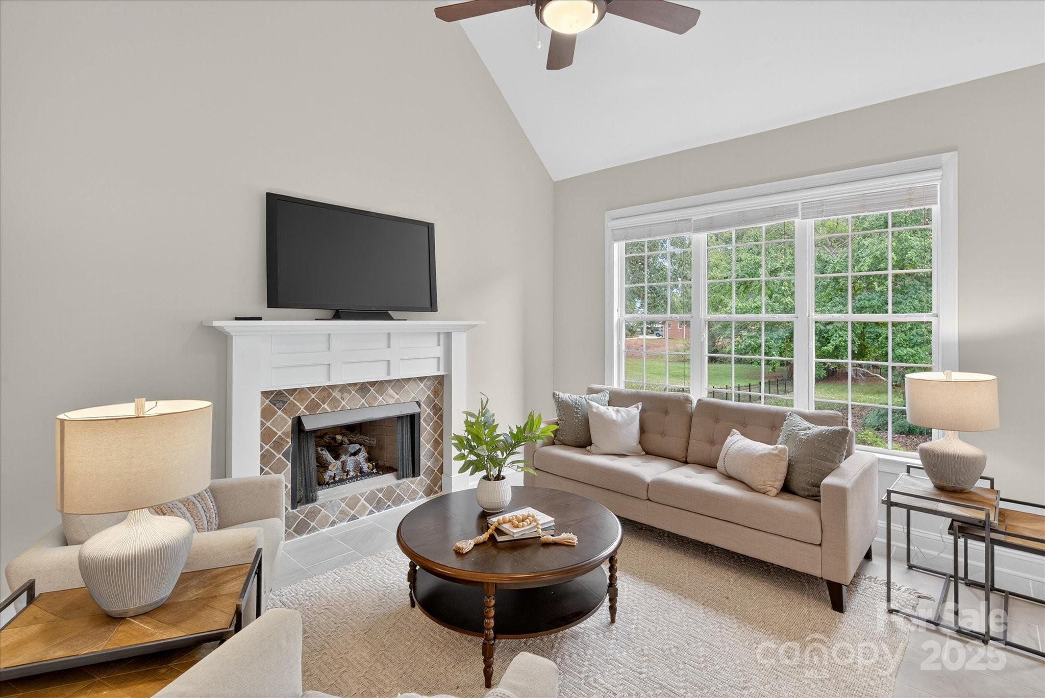 1912 Windmere Drive Monroe, NC 28110 - Photo 11 of 37 a living room with furniture a flat screen tv and a fireplace