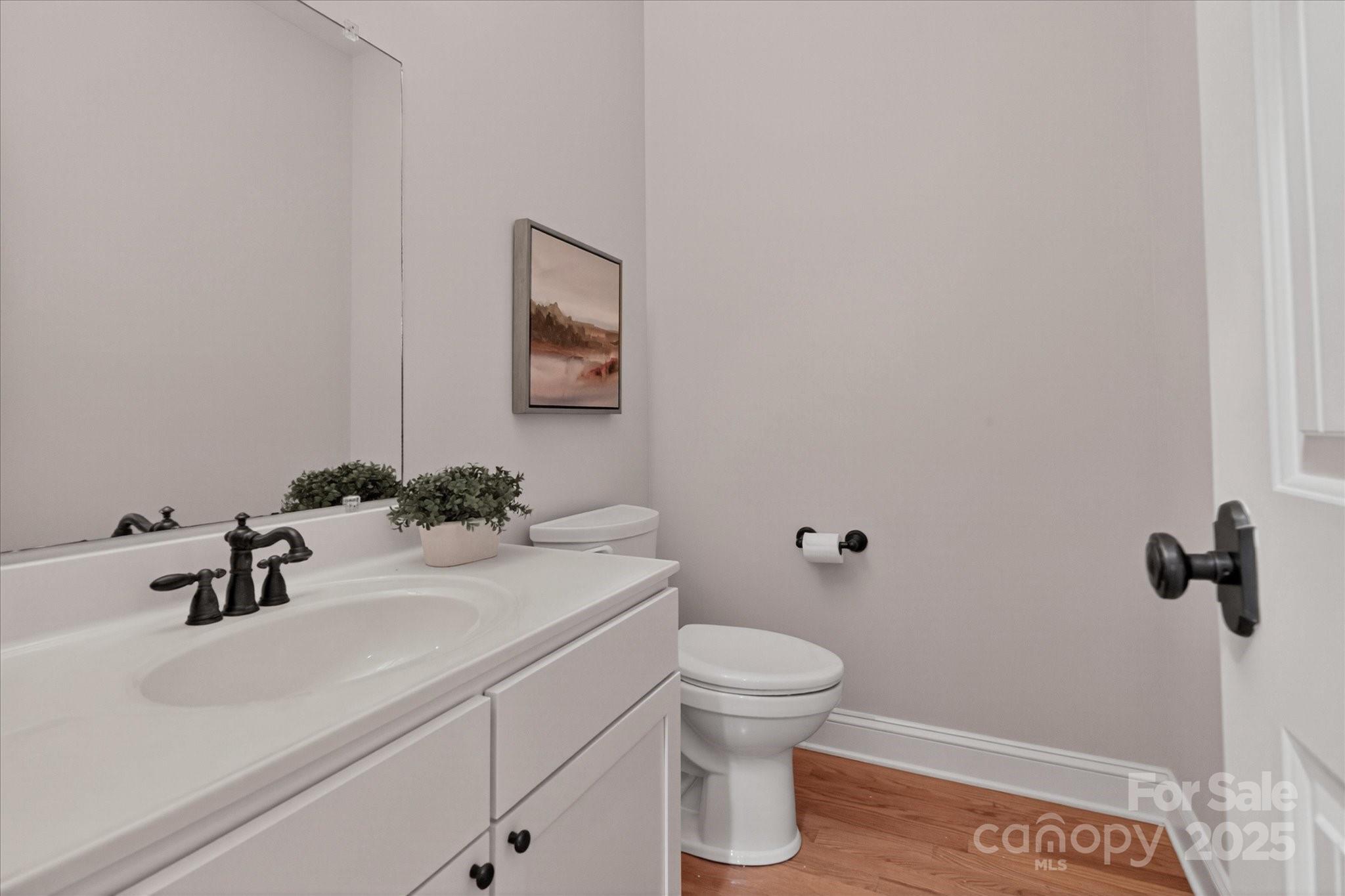 1912 Windmere Drive Monroe, NC 28110 - Photo 16 of 37 a bathroom with a sink a toilet and mirror