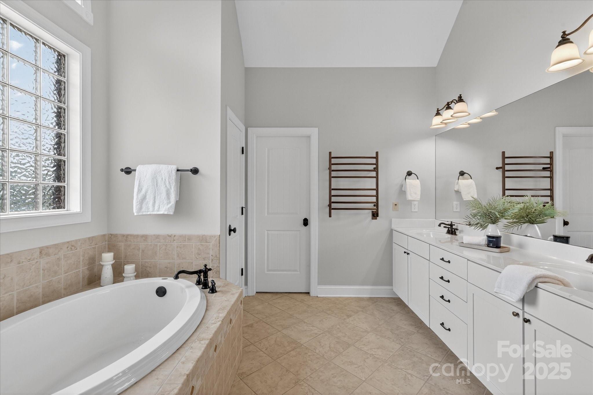1912 Windmere Drive Monroe, NC 28110 - Photo 18 of 37 a bathroom with a tub sink double vanity granite and a bathtub