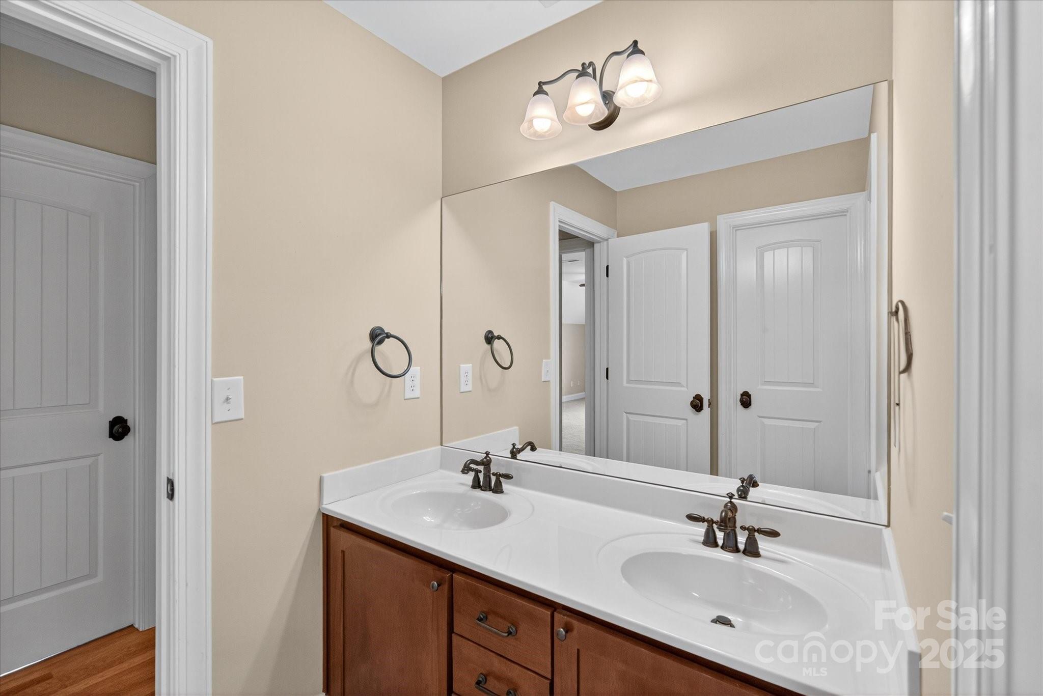 1912 Windmere Drive Monroe, NC 28110 - Photo 25 of 37 a bathroom with a double vanity sink and a mirror