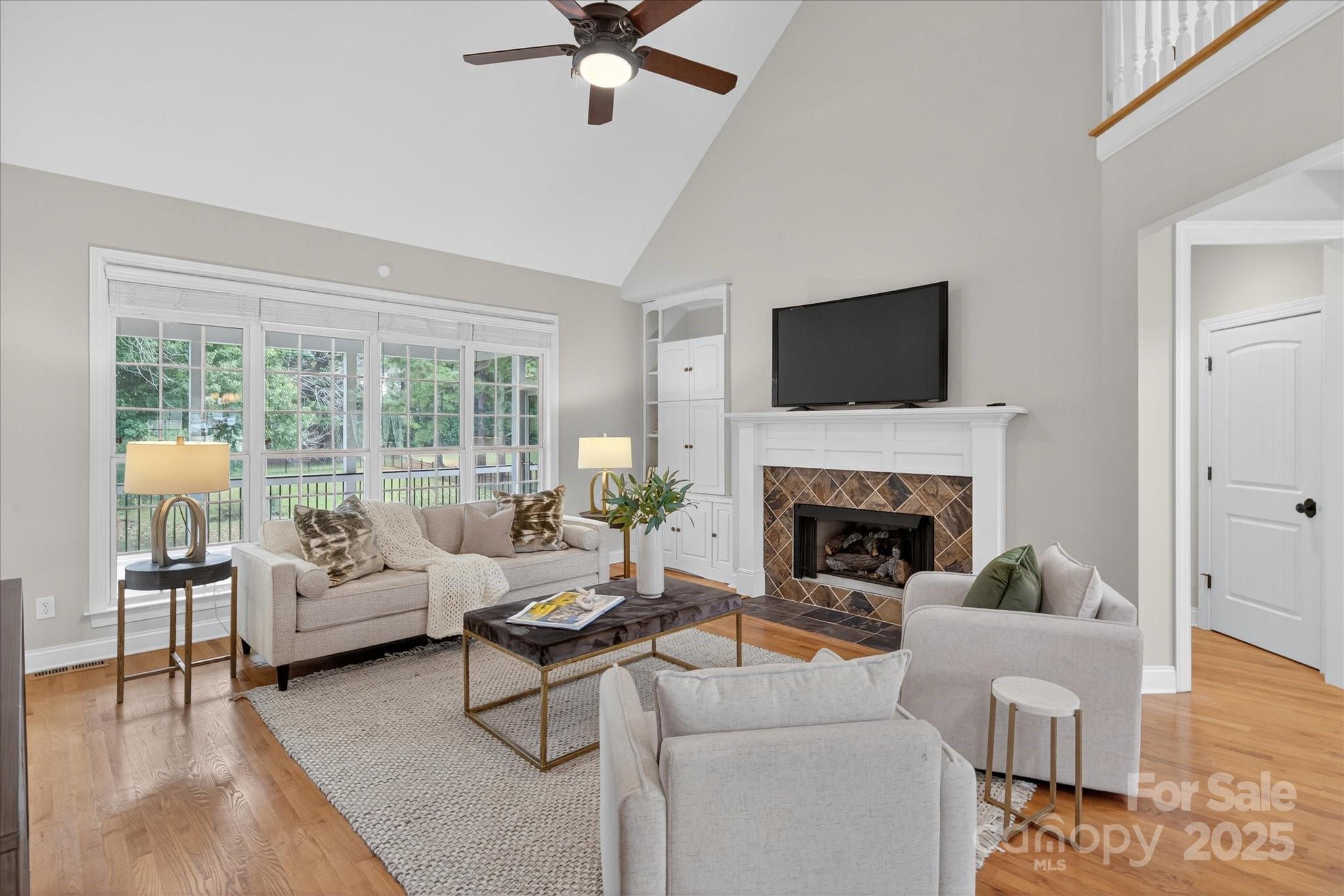 1912 Windmere Drive Monroe, NC 28110 - Photo 5 of 37 a living room with furniture a fireplace and a flat screen tv