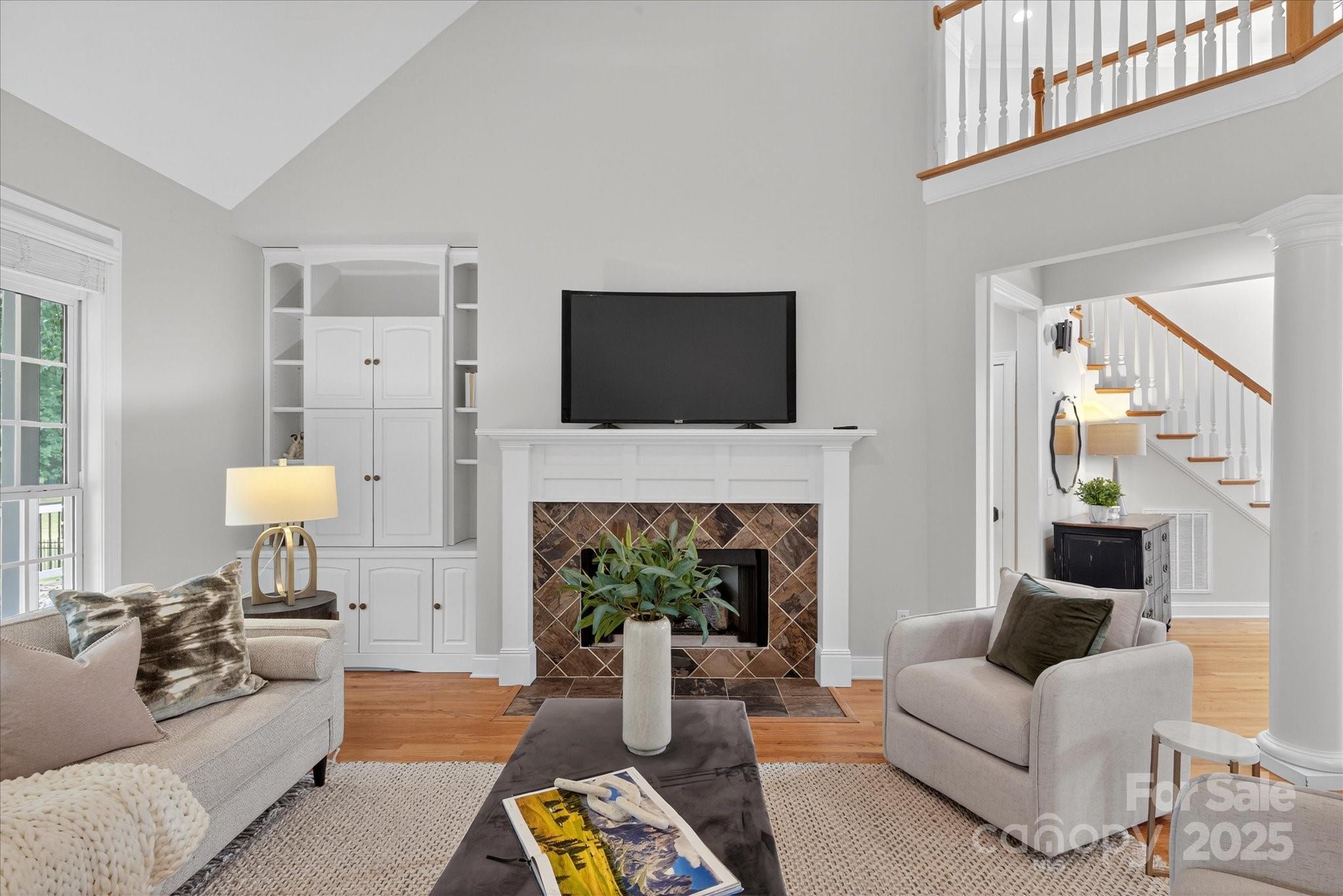 1912 Windmere Drive Monroe, NC 28110 - Photo 6 of 37 a living room with furniture a fireplace and a flat screen tv