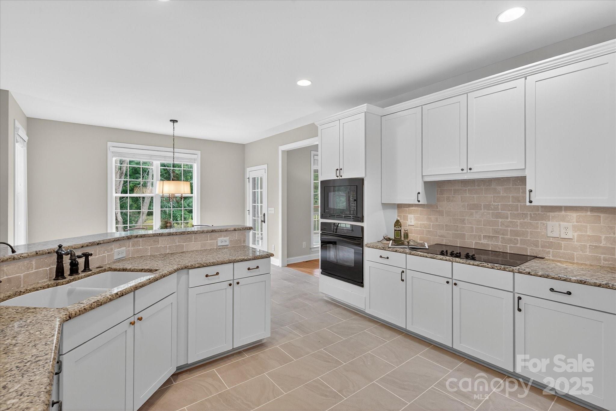 1912 Windmere Drive Monroe, NC 28110 - Photo 9 of 37 a kitchen with stainless steel appliances granite countertop a sink and cabinets