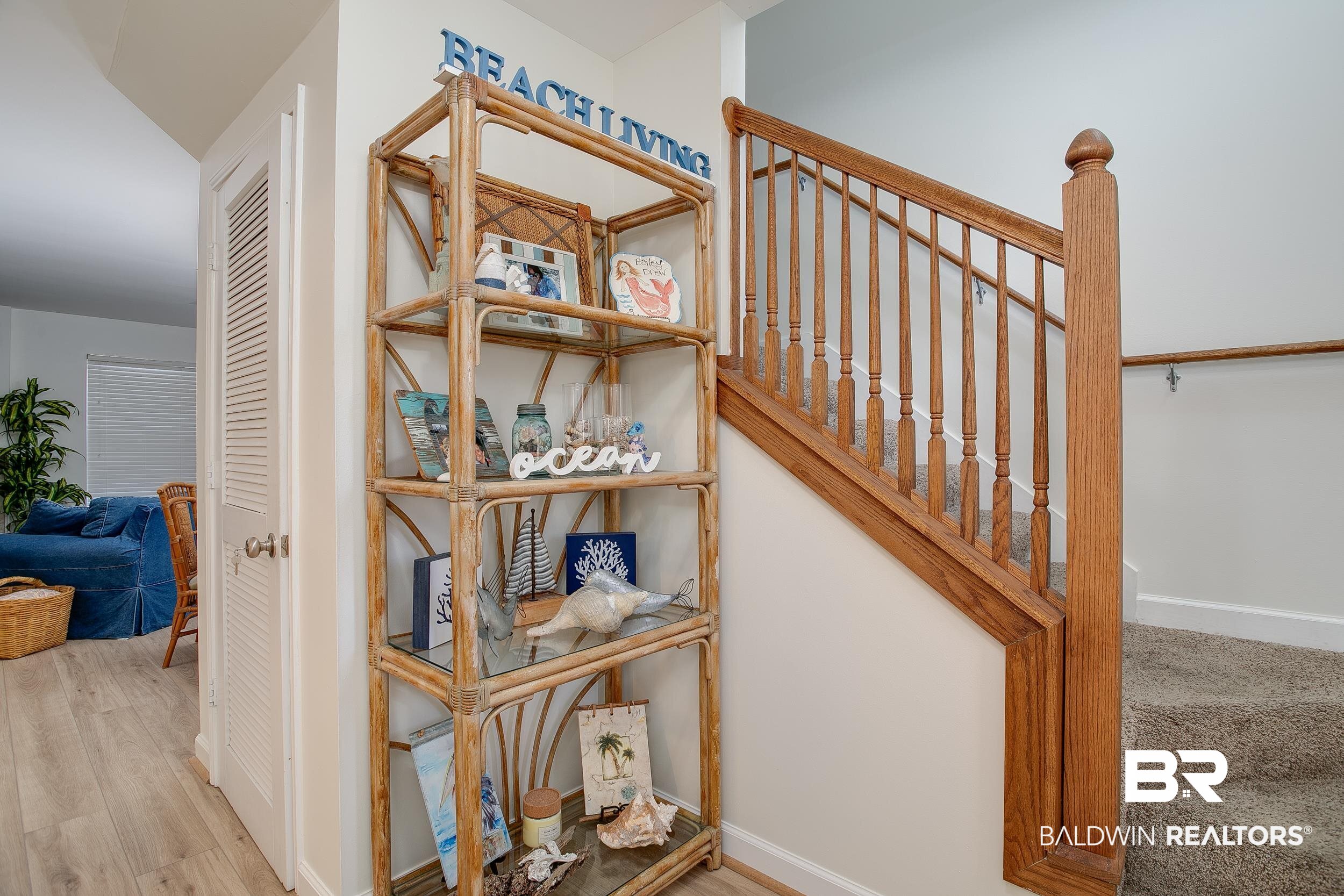 1517 Regency Road, Unit 33 Gulf Shores, AL 36542 - Photo 13 of 29 Stairs with baseboards and wood finished floors