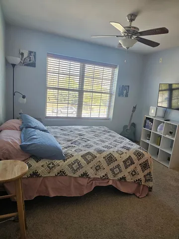 a bedroom with a bed and a window