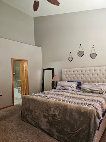 a bedroom with a bed and lamp