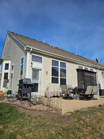 a front view of a house with cars parked