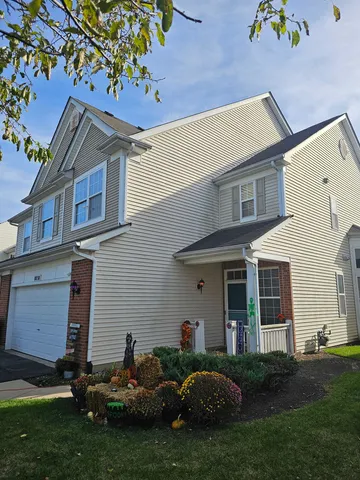 a backyard of a house with table and chairs