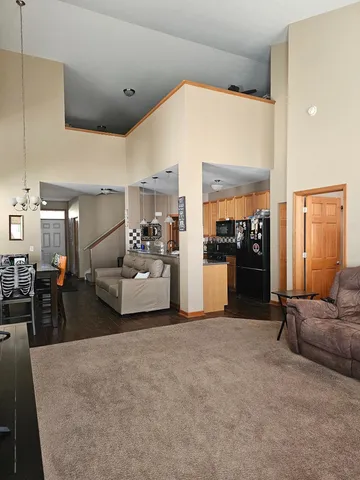 a living room with furniture and kitchen view