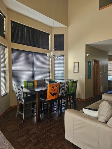 a living room with furniture a flat screen tv and kitchen view