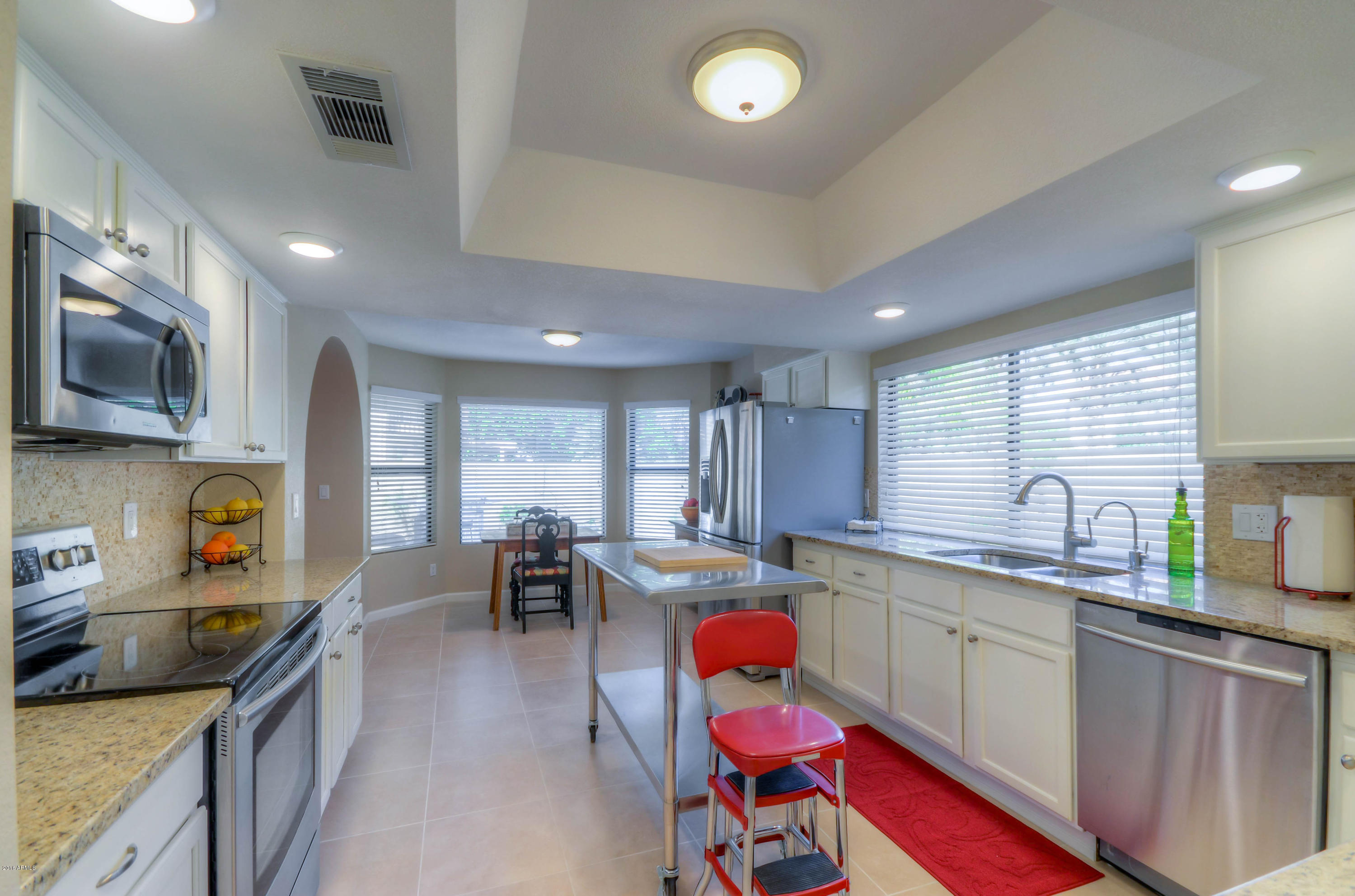1433 North Woodside Road Chandler, AZ 85224 - Photo 18 of 70 a kitchen that has a lot of cabinets in it and appliances