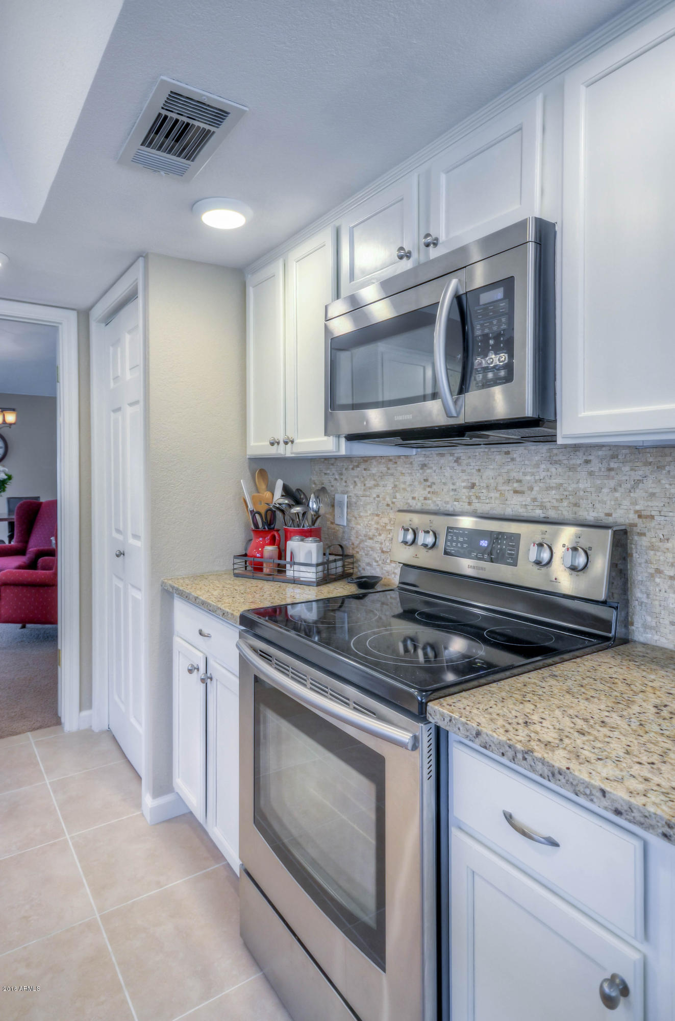 1433 North Woodside Road Chandler, AZ 85224 - Photo 20 of 70 a kitchen with stainless steel appliances granite countertop a stove and a sink