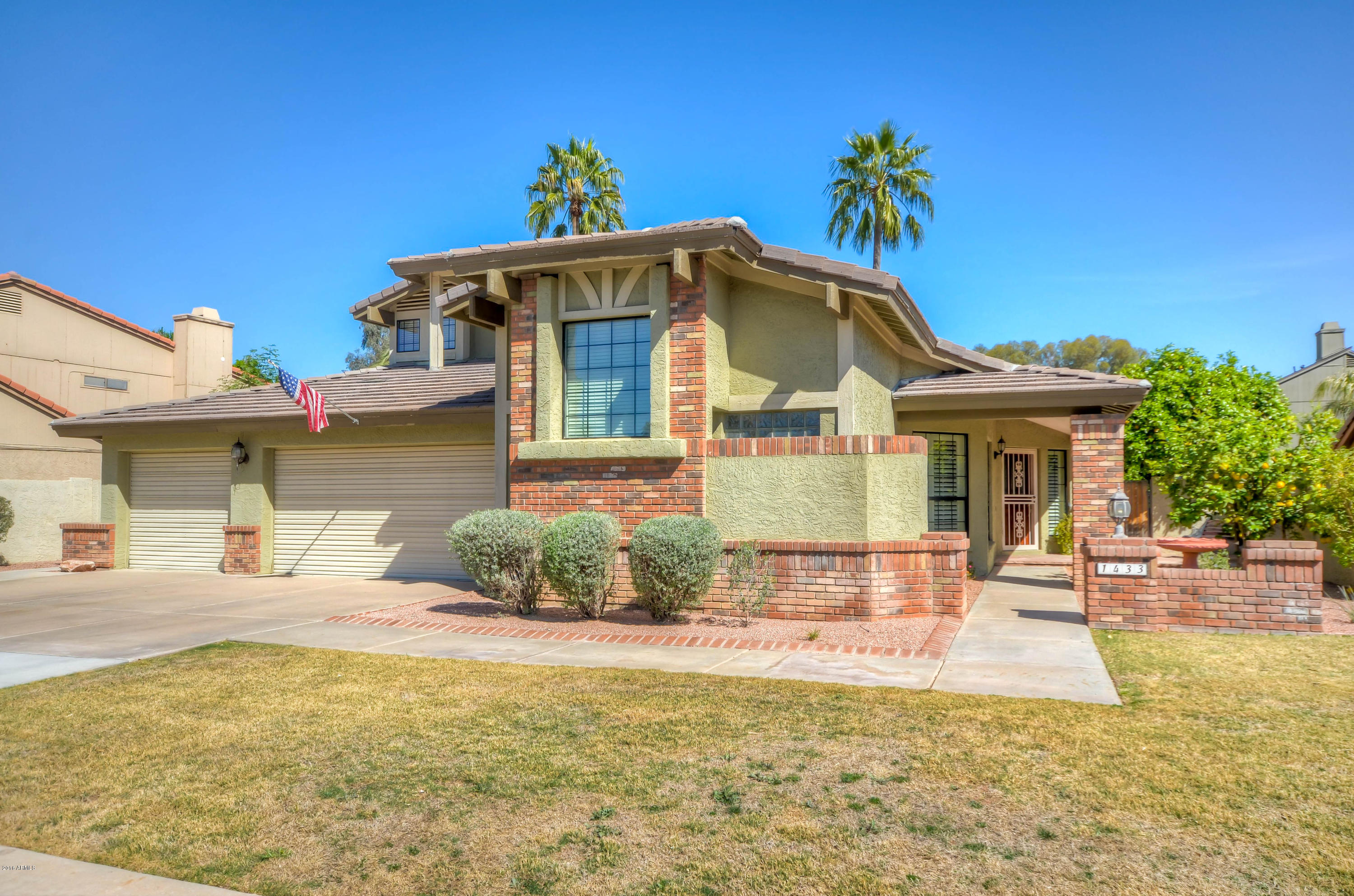 1433 North Woodside Road Chandler, AZ 85224 - Photo 2 of 70 a front view of a house with a yard