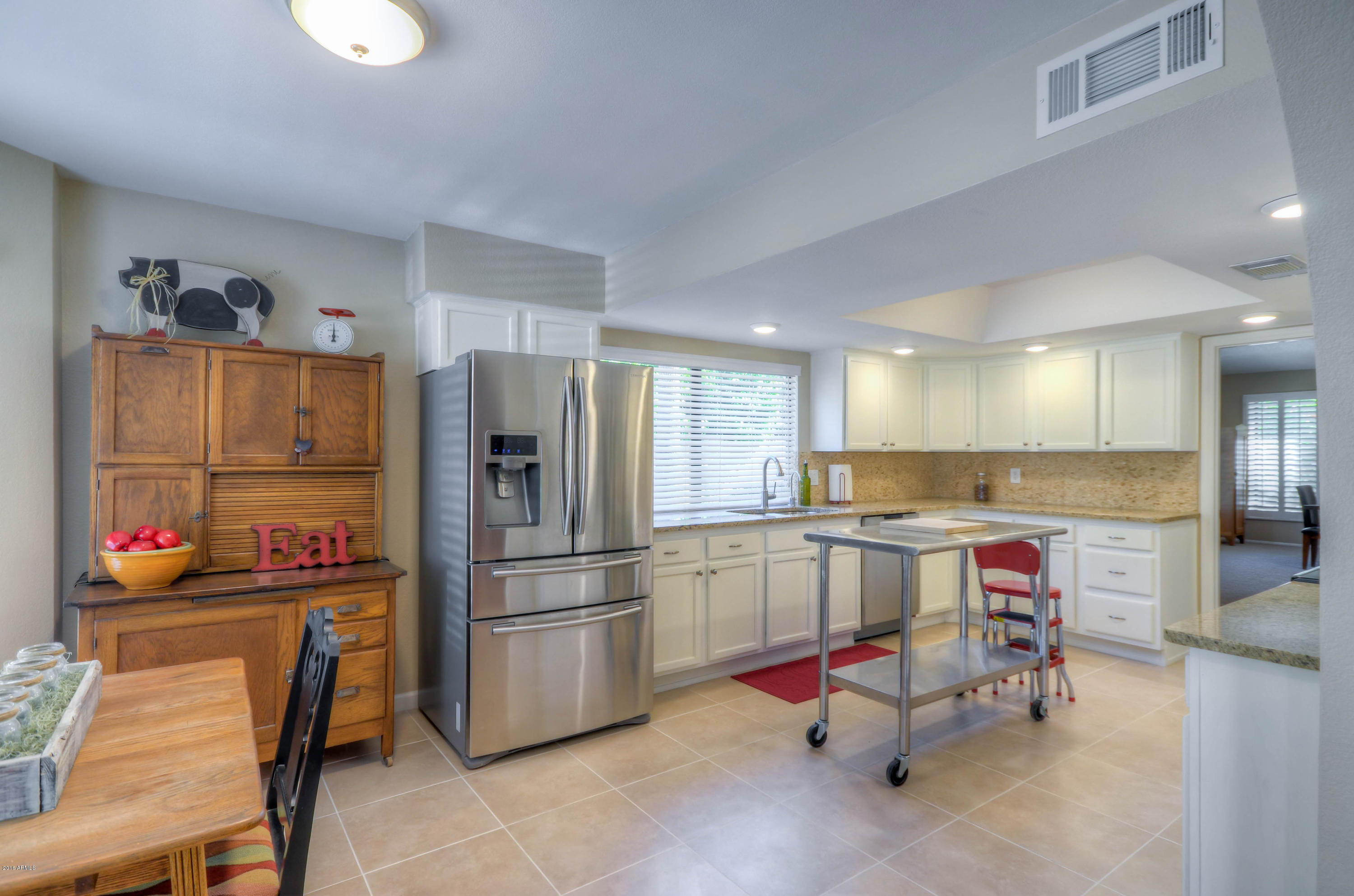 1433 North Woodside Road Chandler, AZ 85224 - Photo 23 of 70 a kitchen with stainless steel appliances granite countertop a refrigerator and a stove top oven