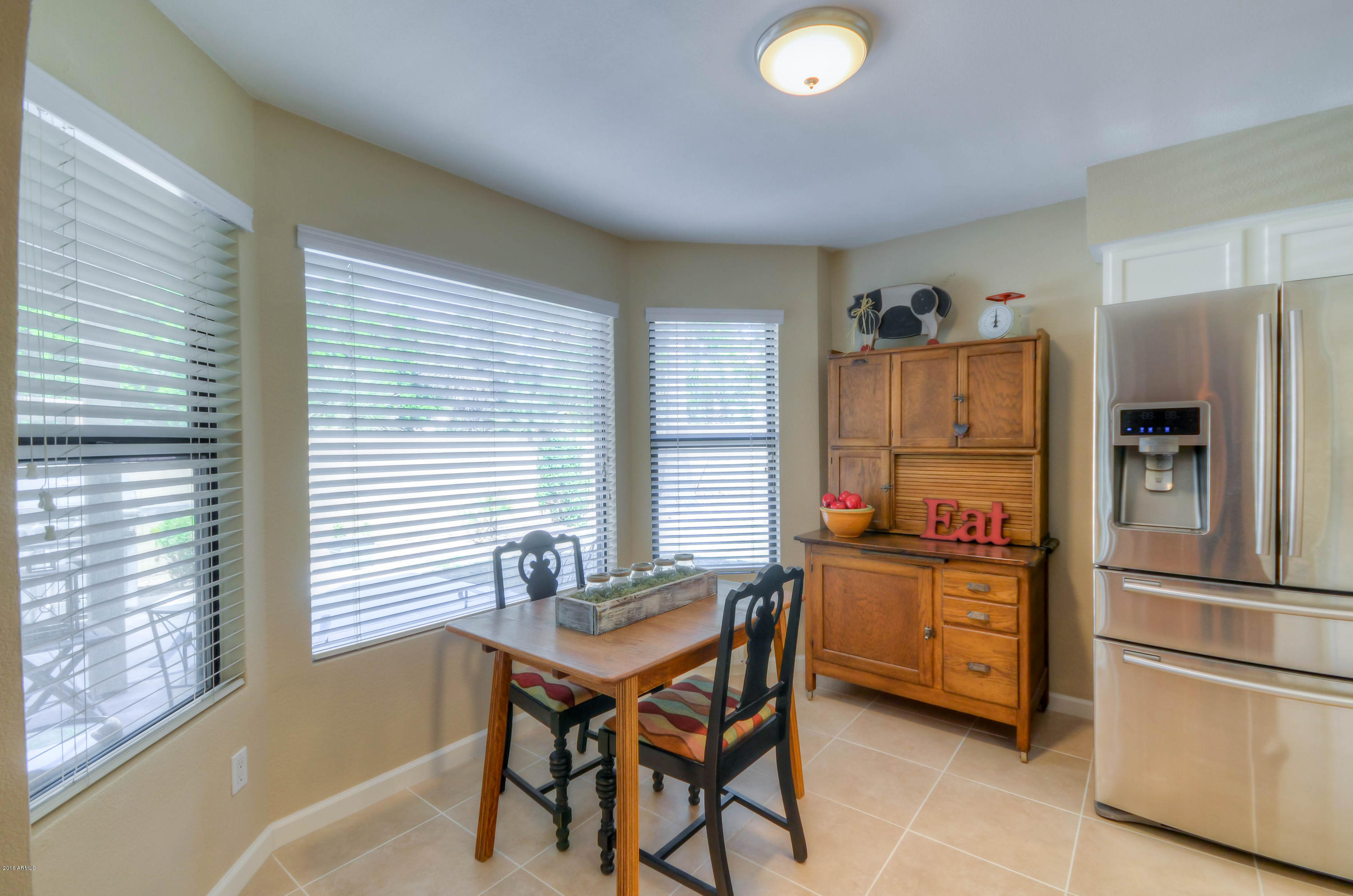 1433 North Woodside Road Chandler, AZ 85224 - Photo 24 of 70 a kitchen with a refrigerator a stove and a dining table