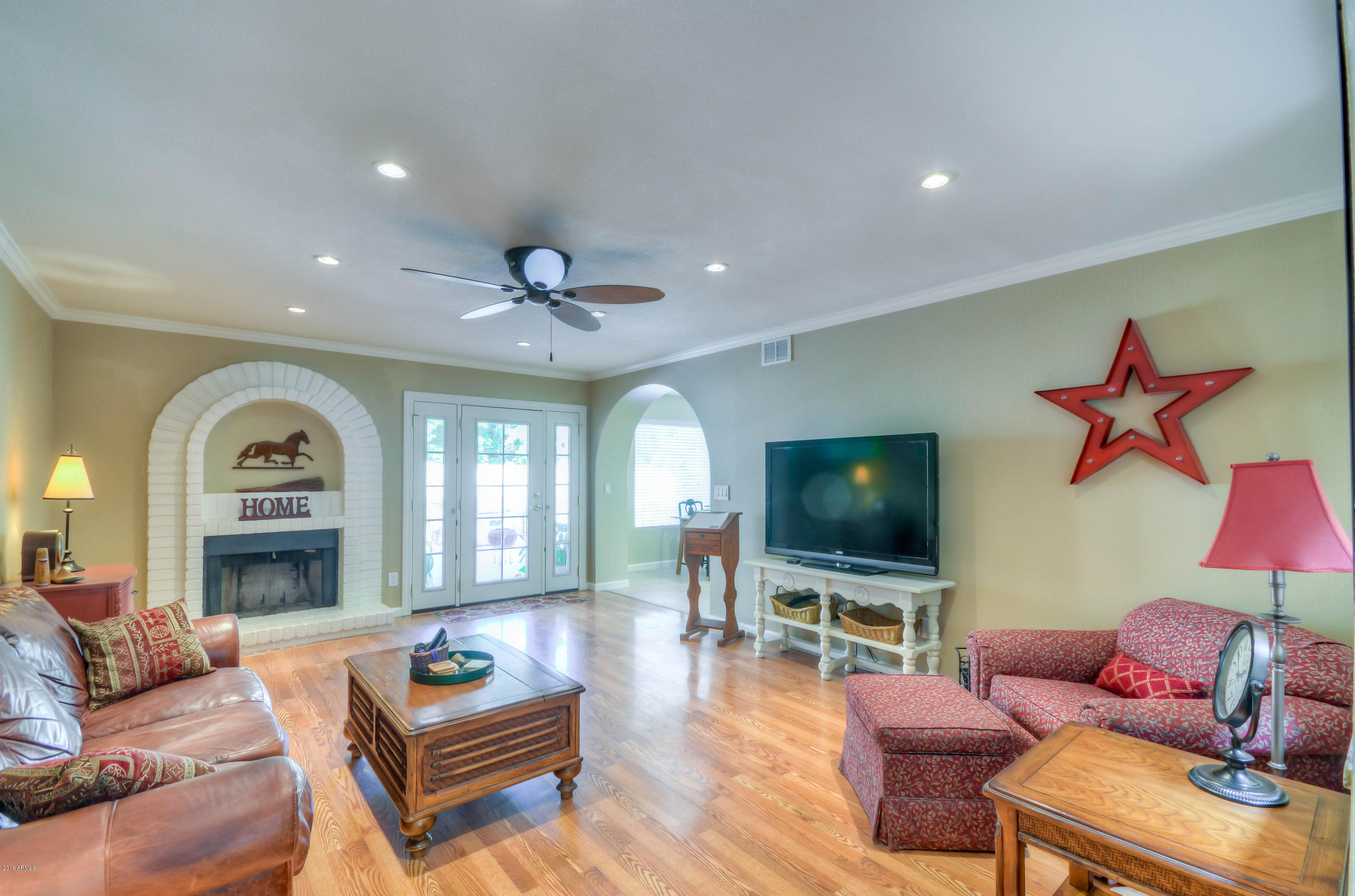 1433 North Woodside Road Chandler, AZ 85224 - Photo 27 of 70 a living room with furniture a flat screen tv and a fireplace