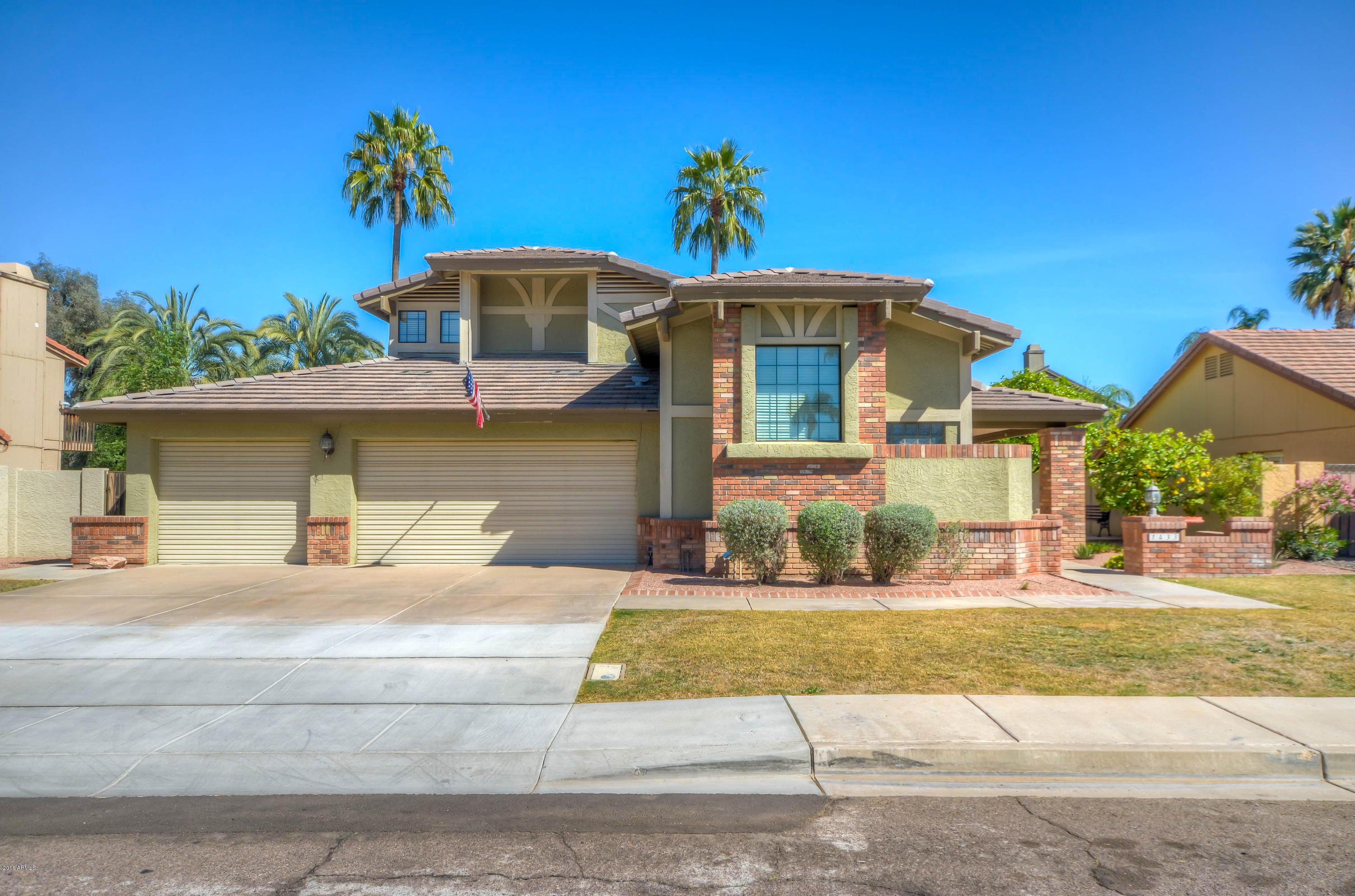 1433 North Woodside Road Chandler, AZ 85224 - Photo 3 of 70 a front view of a house with a yard