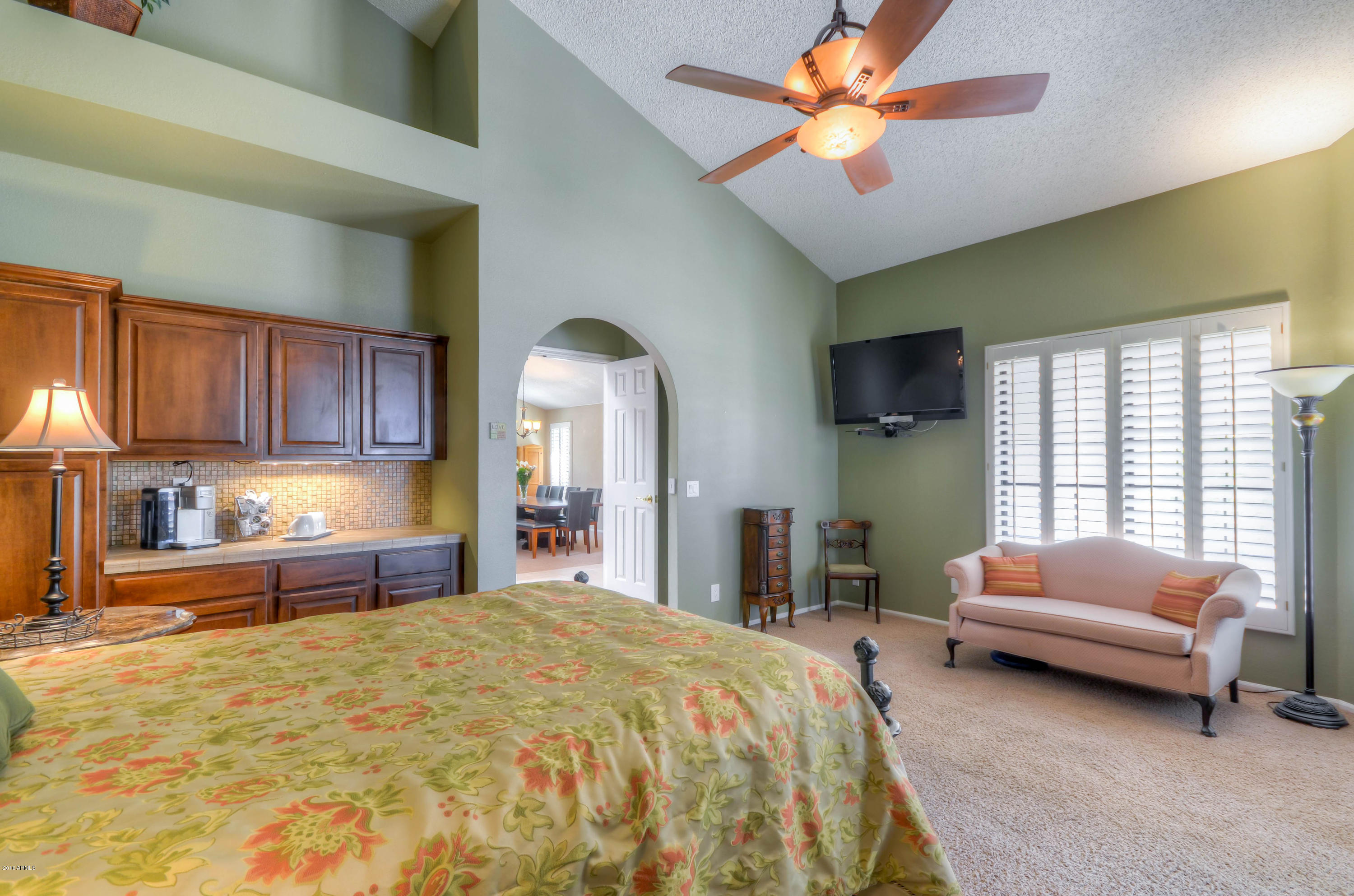 1433 North Woodside Road Chandler, AZ 85224 - Photo 35 of 70 a spacious bedroom with a bed and a chandelier