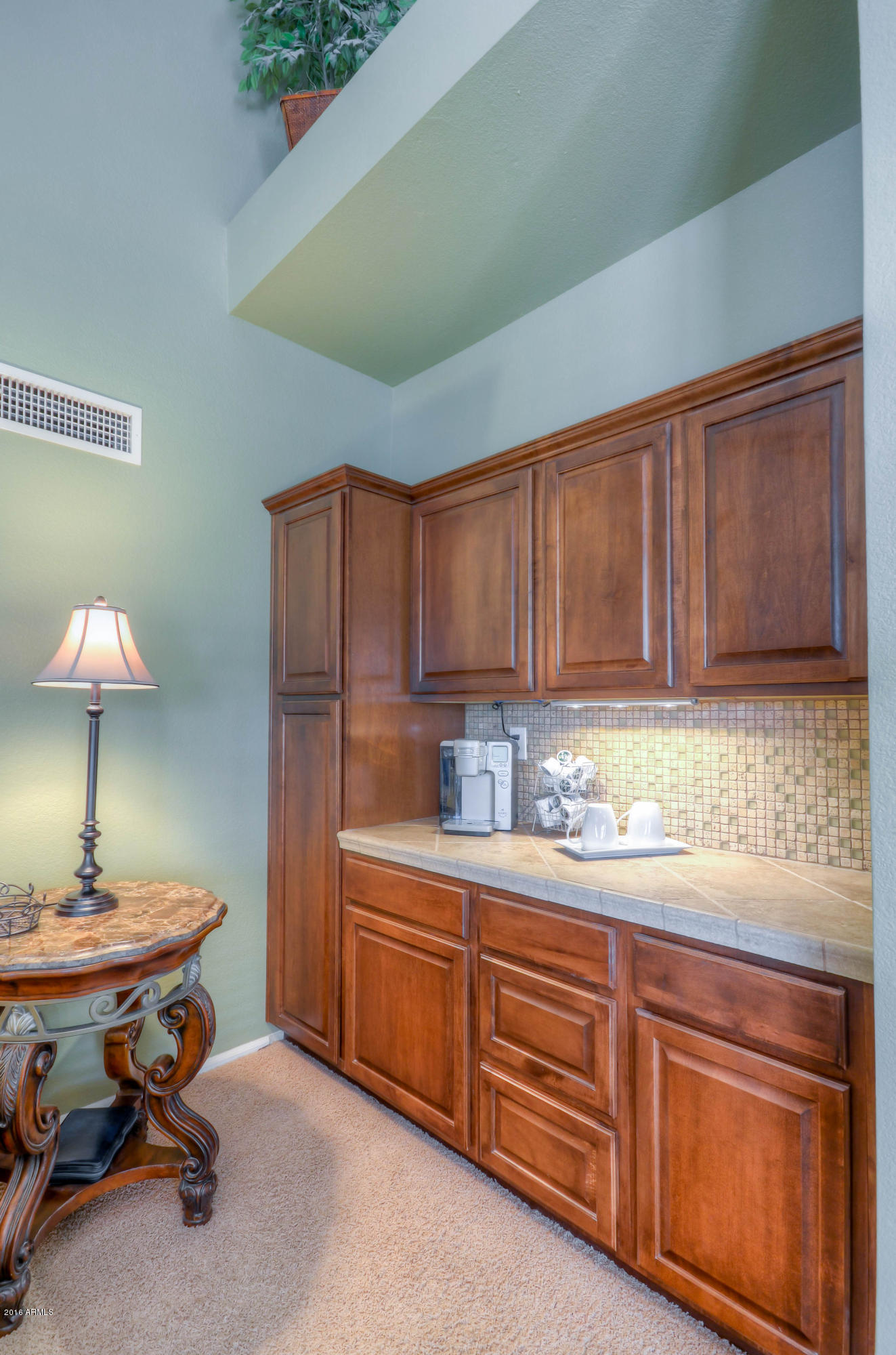 1433 North Woodside Road Chandler, AZ 85224 - Photo 36 of 70 a kitchen with stainless steel appliances kitchen island granite countertop a table chairs in it and wooden cabinets