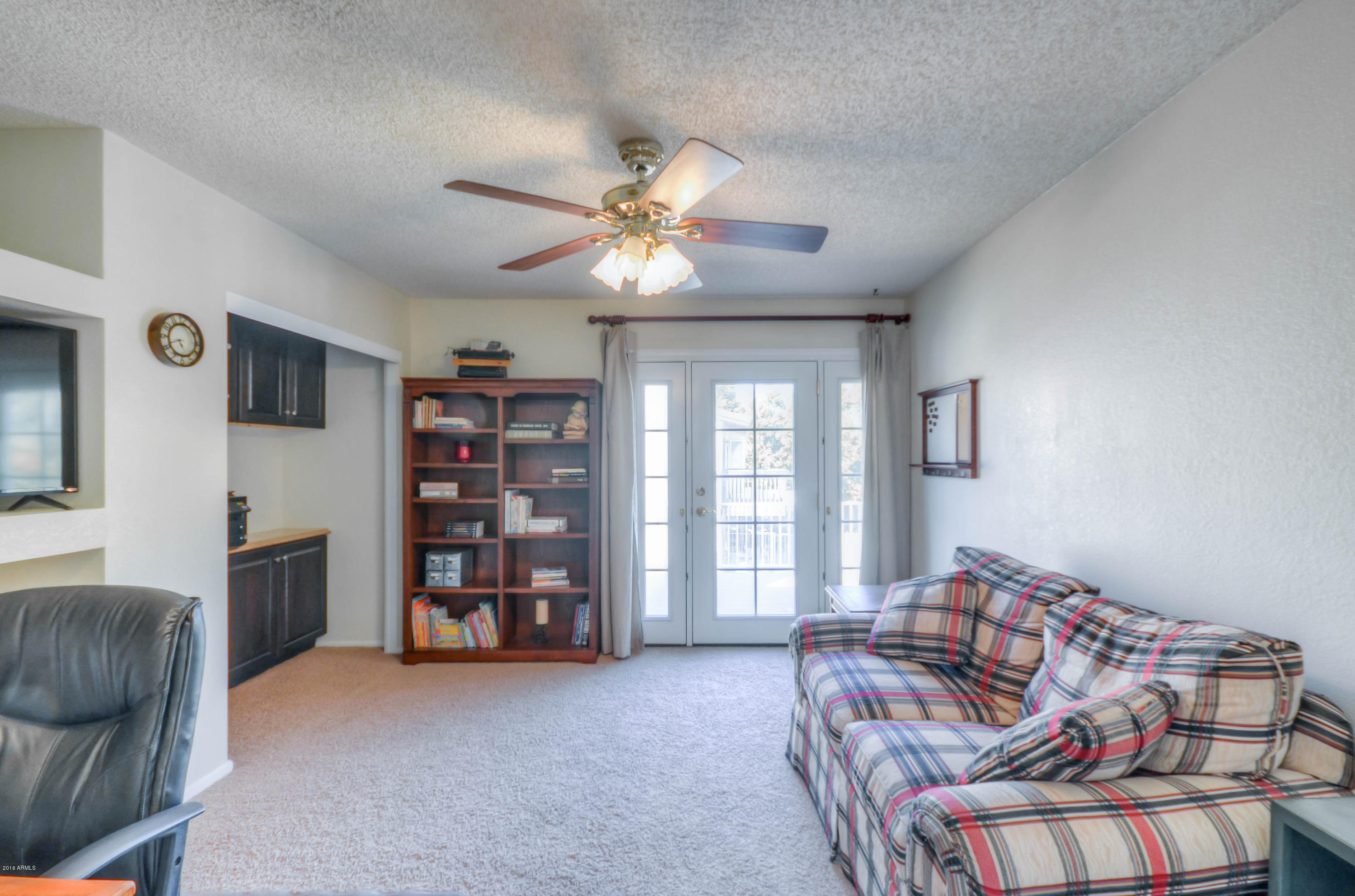 1433 North Woodside Road Chandler, AZ 85224 - Photo 49 of 70 a living room with furniture and a bookshelf