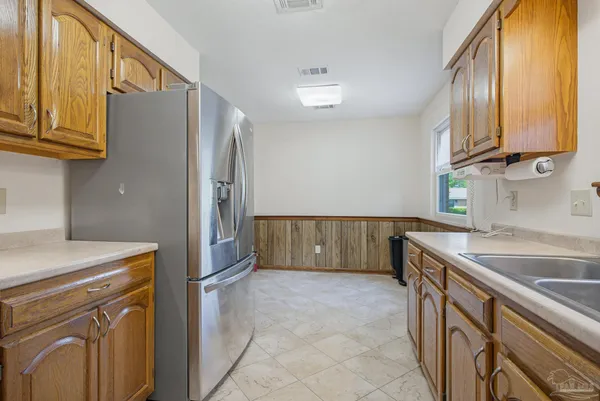 a view of kitchen with stainless steel appliances granite countertop a sink and a microwave