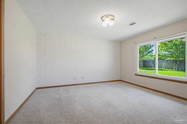 a view of walk in closet with clothes