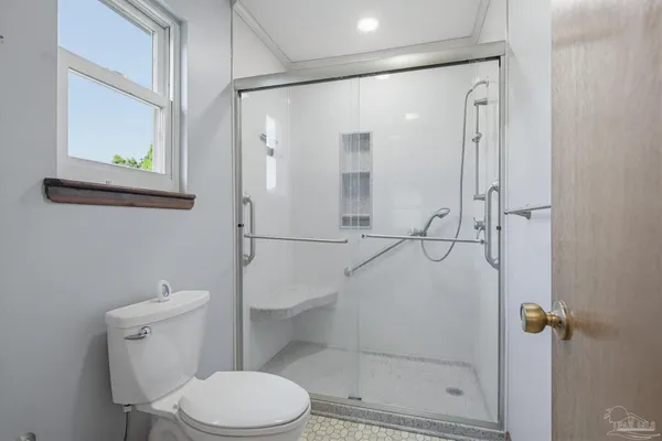 a view of a bathroom from a hallway