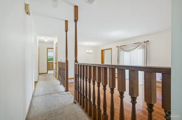 a view of a room with wooden floor and fence