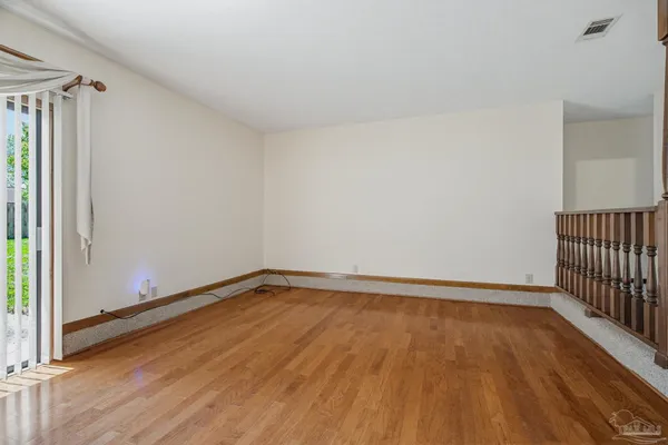 a view of a room with wooden floor and windows