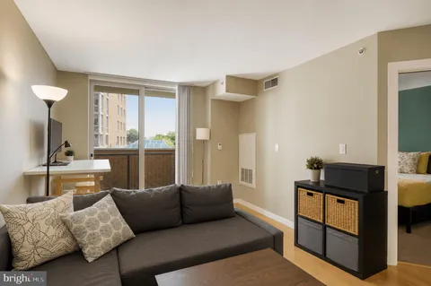 a living room with furniture and a dresser