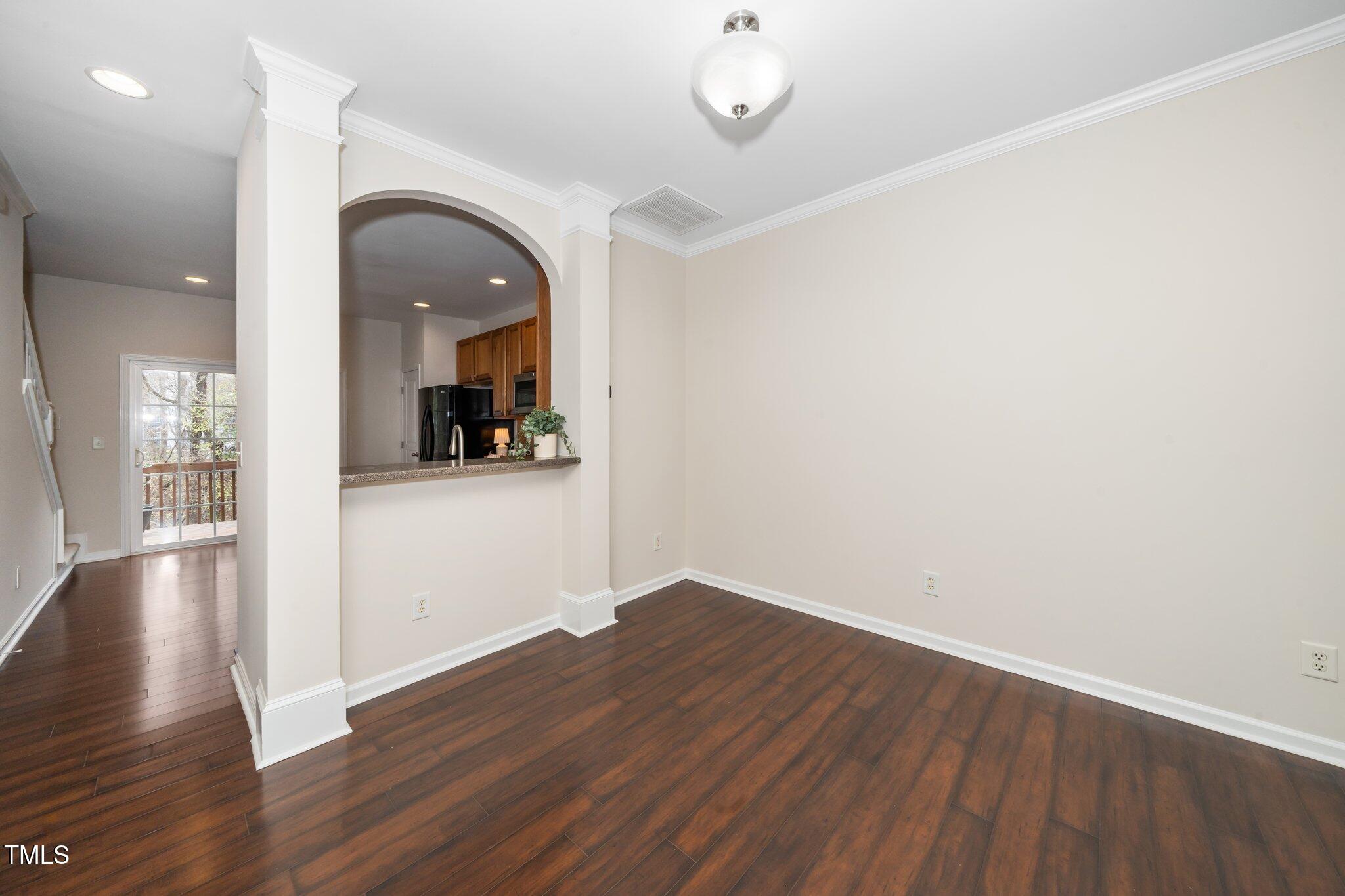 7753 Winners Edge Street Raleigh, NC 27617 - Photo 10 of 46 an empty room with wooden floor and windows