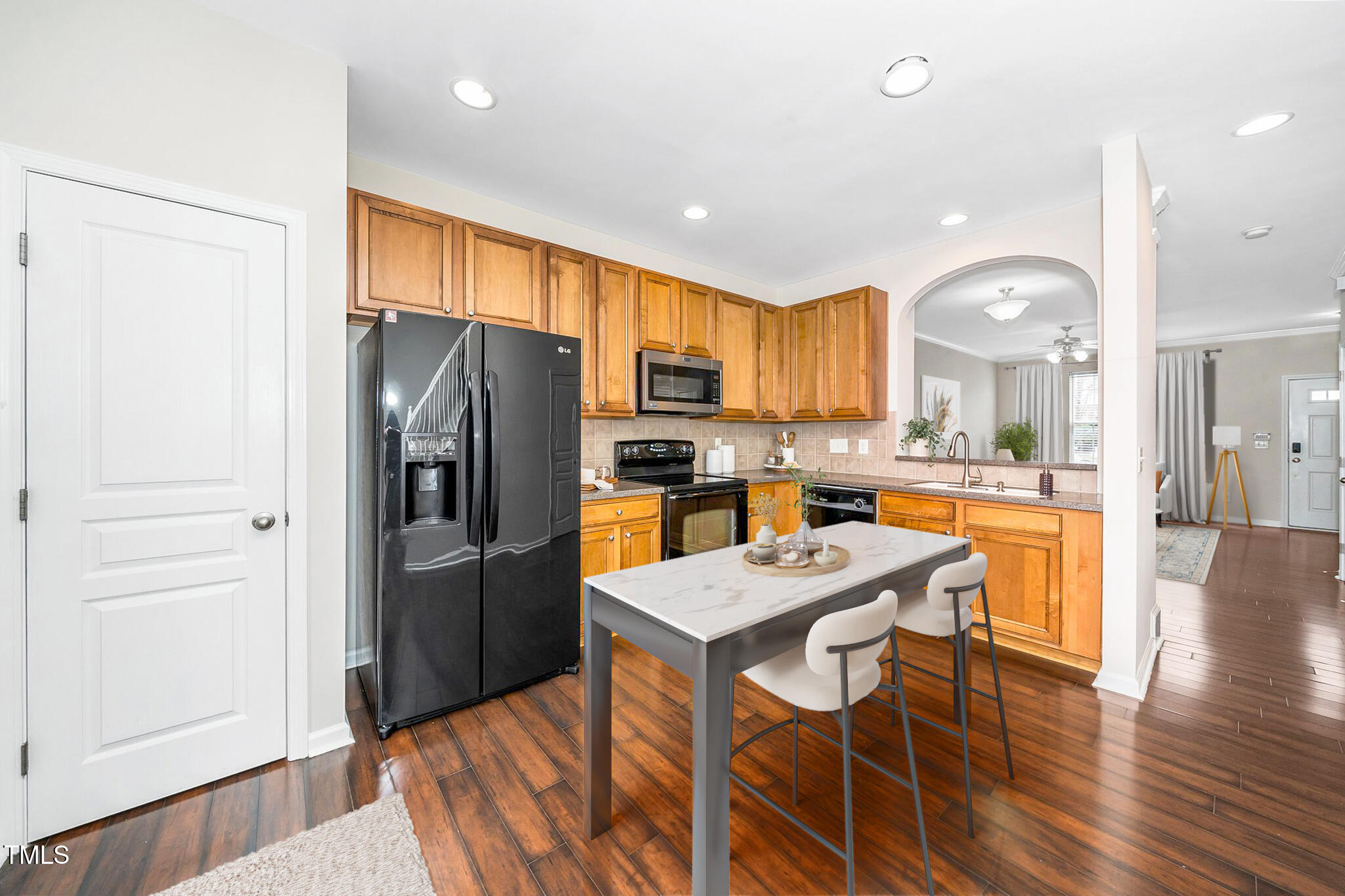 7753 Winners Edge Street Raleigh, NC 27617 - Photo 11 of 46 a kitchen with stainless steel appliances granite countertop a refrigerator a stove microwave and cabinets